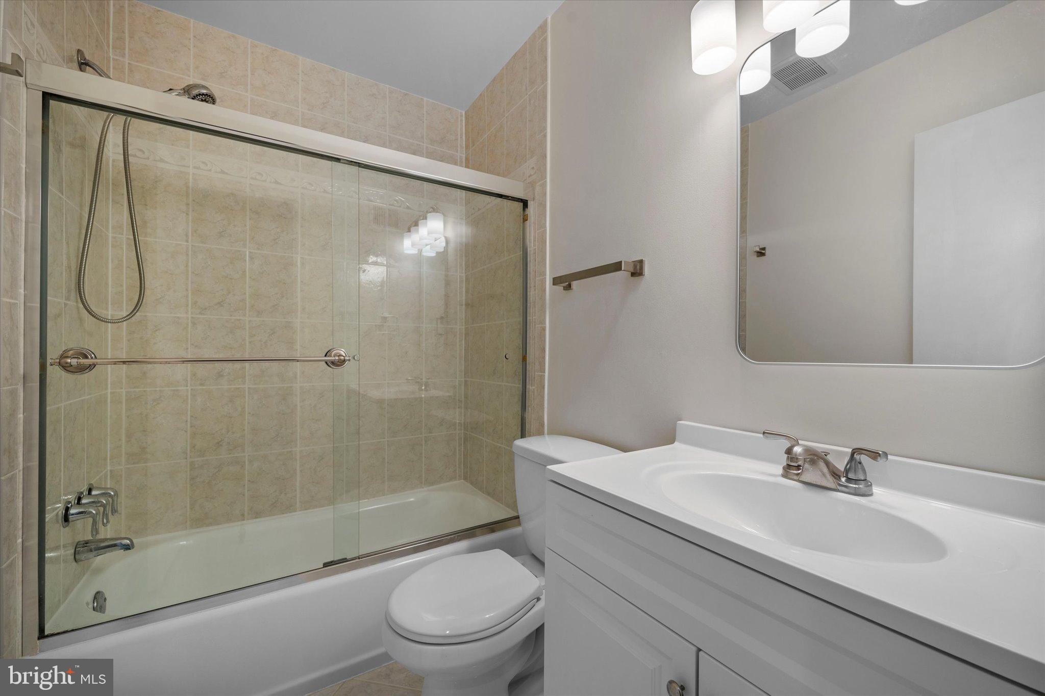 10276 Arizona Circle, Unit 61 Bethesda, MD 20817 - Photo 24 of 42 a bathroom with a sink toilet and shower