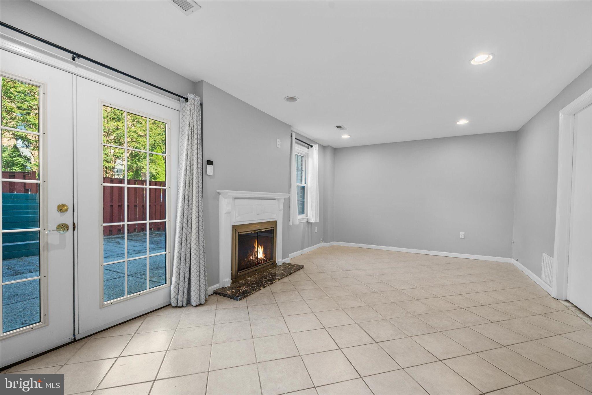 10276 Arizona Circle, Unit 61 Bethesda, MD 20817 - Photo 27 of 42 a view of an empty room with a fireplace and a window