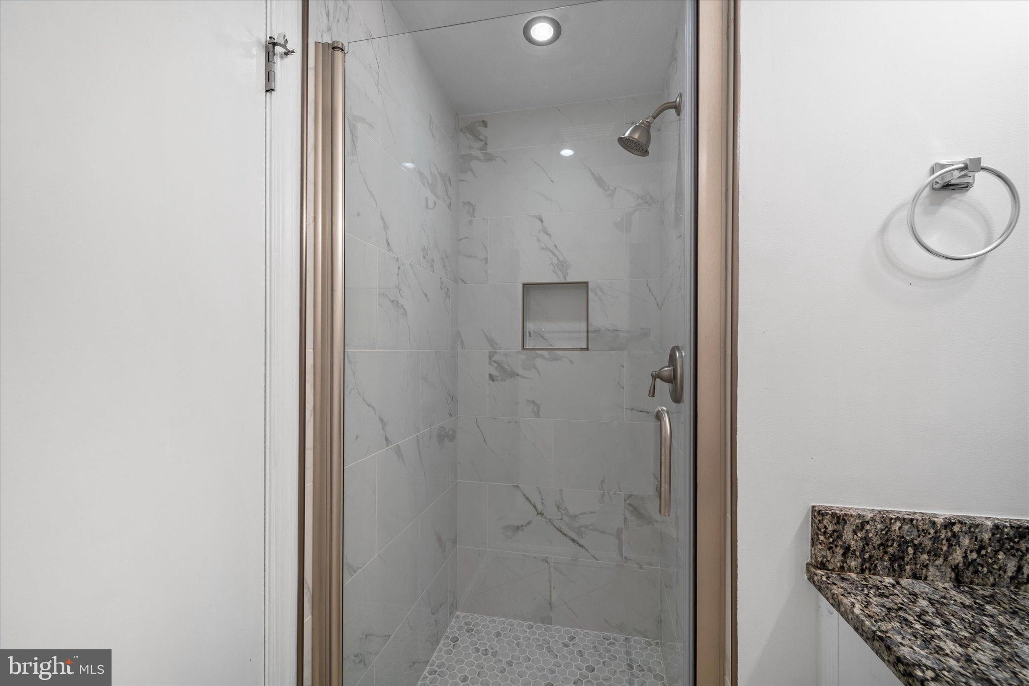 10276 Arizona Circle, Unit 61 Bethesda, MD 20817 - Photo 33 of 42 a bathroom with a glass shower door