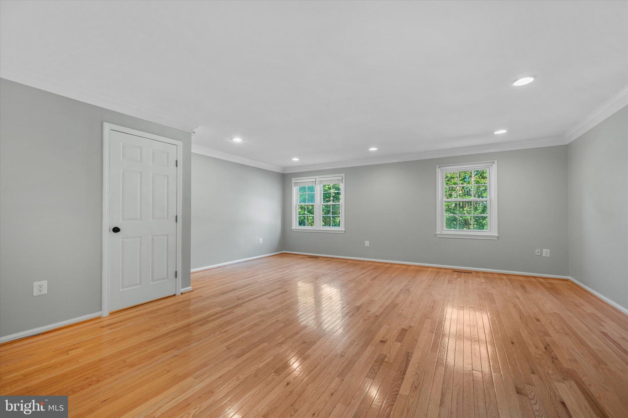 10276 Arizona Circle, Unit 61 Bethesda, MD 20817 - Photo 9 of 42 an empty room with wooden floor and windows