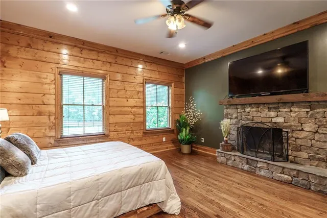 a bedroom with a bed and a ceiling fan