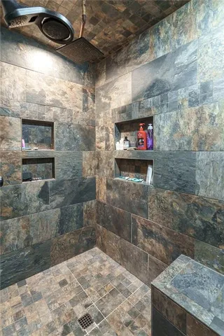 a backyard of a house with lawn chairs and large tree