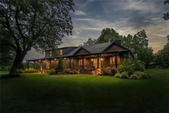 a view of a big yard with table and chairs under an umbrella