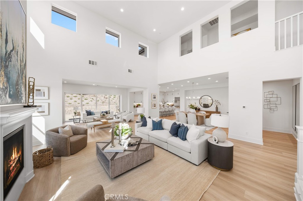 a living room with furniture fireplace and a large window