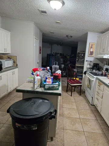a kitchen with a sink appliances and cabinets