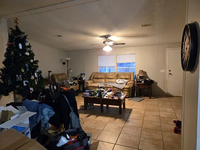 a living room with furniture a dining table and a chandelier