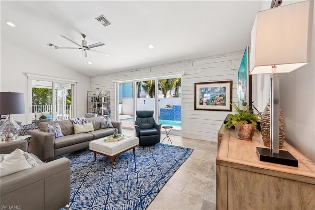 161 Tahiti Circle Naples, FL 34113 - Photo 14 of 42 a living room with furniture and a large window