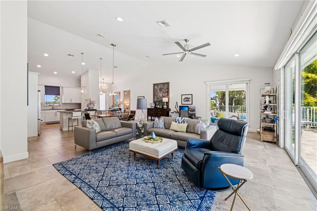 161 Tahiti Circle Naples, FL 34113 - Photo 15 of 42 a living room with furniture or kitchen view and a fireplace