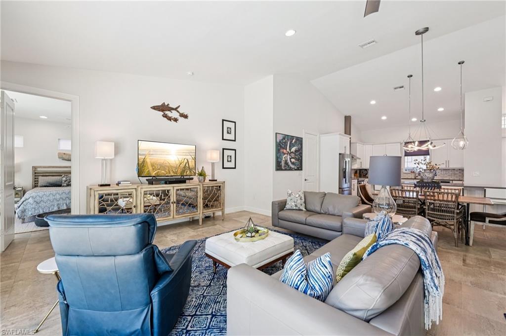 161 Tahiti Circle Naples, FL 34113 - Photo 16 of 42 a living room with furniture kitchen view and a flat screen tv