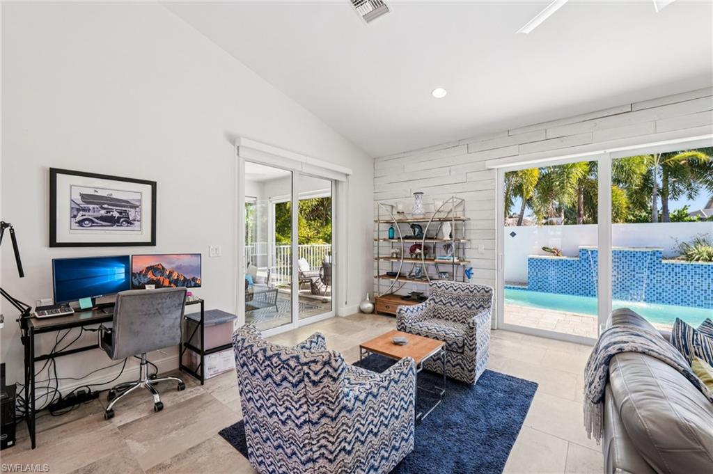 161 Tahiti Circle Naples, FL 34113 - Photo 17 of 42 a living room with furniture floor to ceiling window and a rug