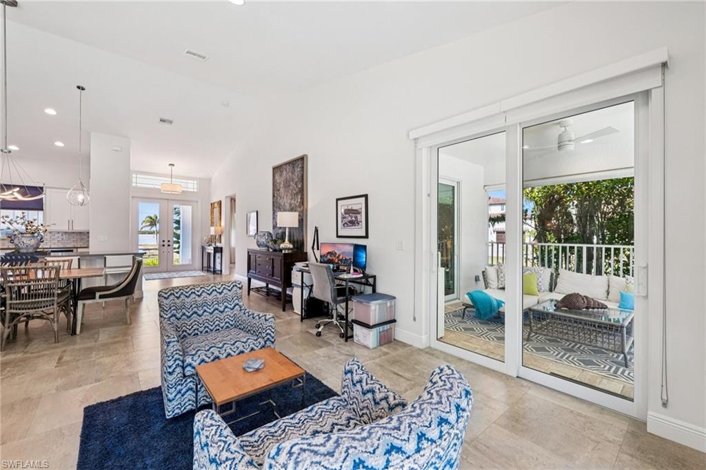 161 Tahiti Circle Naples, FL 34113 - Photo 18 of 42 a living room with furniture and a table