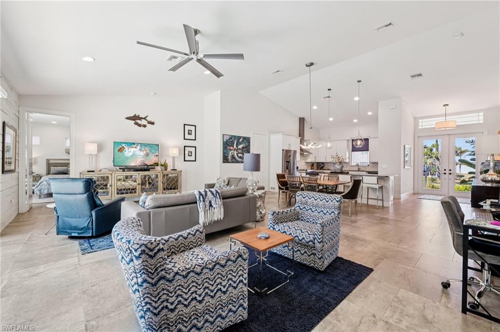 161 Tahiti Circle Naples, FL 34113 - Photo 19 of 42 a living room with furniture or kitchen view and a chandelier