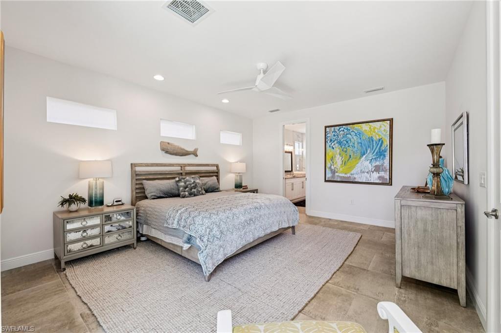 161 Tahiti Circle Naples, FL 34113 - Photo 20 of 42 a bedroom with a bed and painting on the wall