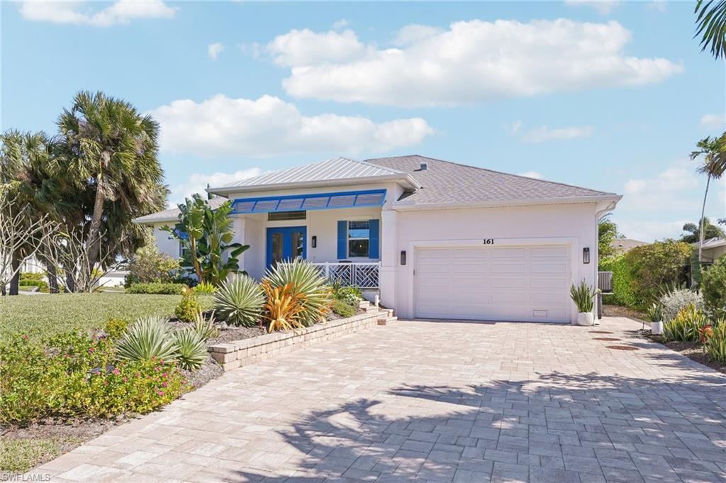161 Tahiti Circle Naples, FL 34113 - Photo 2 of 42 a front view of a house with a yard and garage