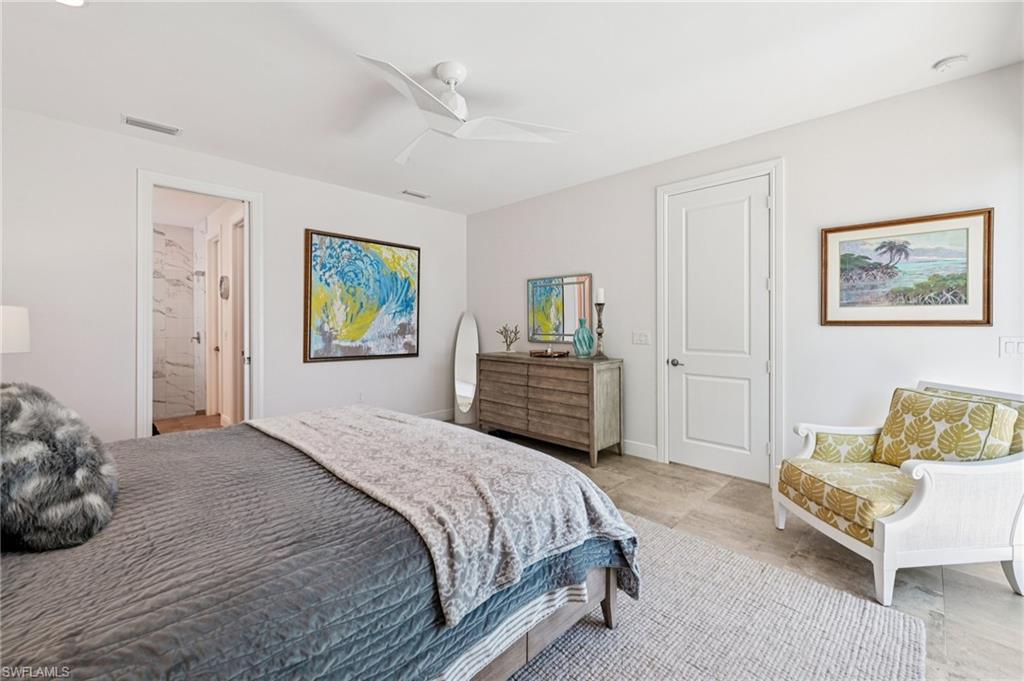 161 Tahiti Circle Naples, FL 34113 - Photo 23 of 42 a spacious bedroom with a bed and a couch
