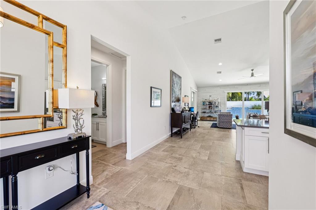 161 Tahiti Circle Naples, FL 34113 - Photo 26 of 42 Hallway with lofted ceiling and recessed lighting