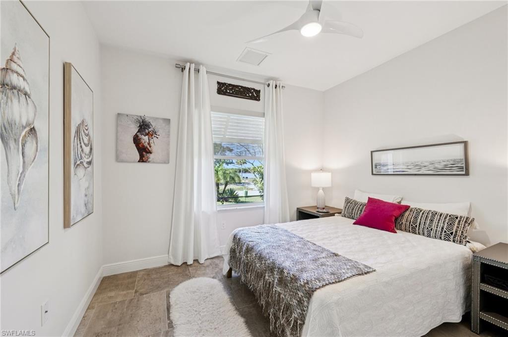 161 Tahiti Circle Naples, FL 34113 - Photo 27 of 42 Bedroom featuring a ceiling fan and baseboards