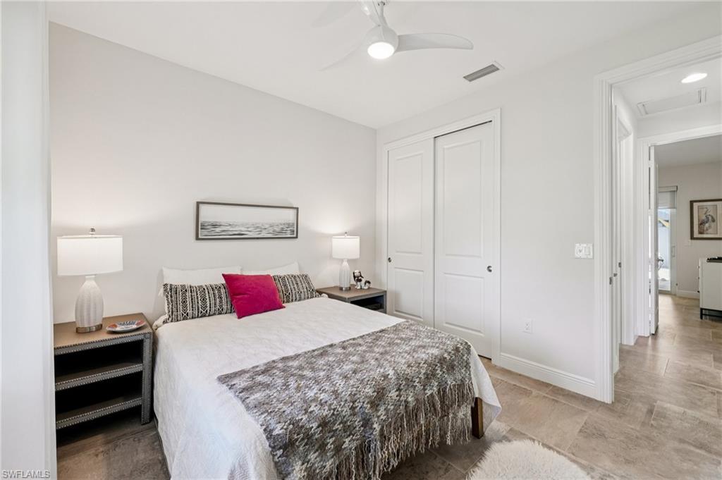 161 Tahiti Circle Naples, FL 34113 - Photo 28 of 42 a bedroom with a bed and a lamp