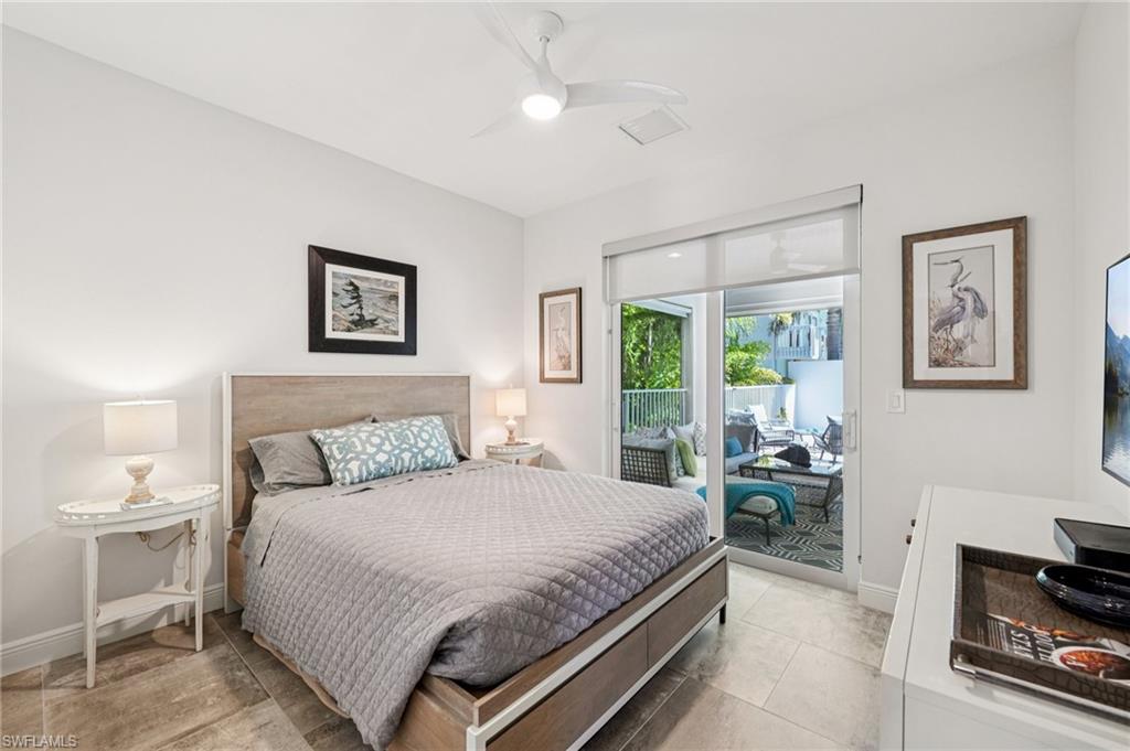 161 Tahiti Circle Naples, FL 34113 - Photo 31 of 42 a bedroom with a bed and a chandelier