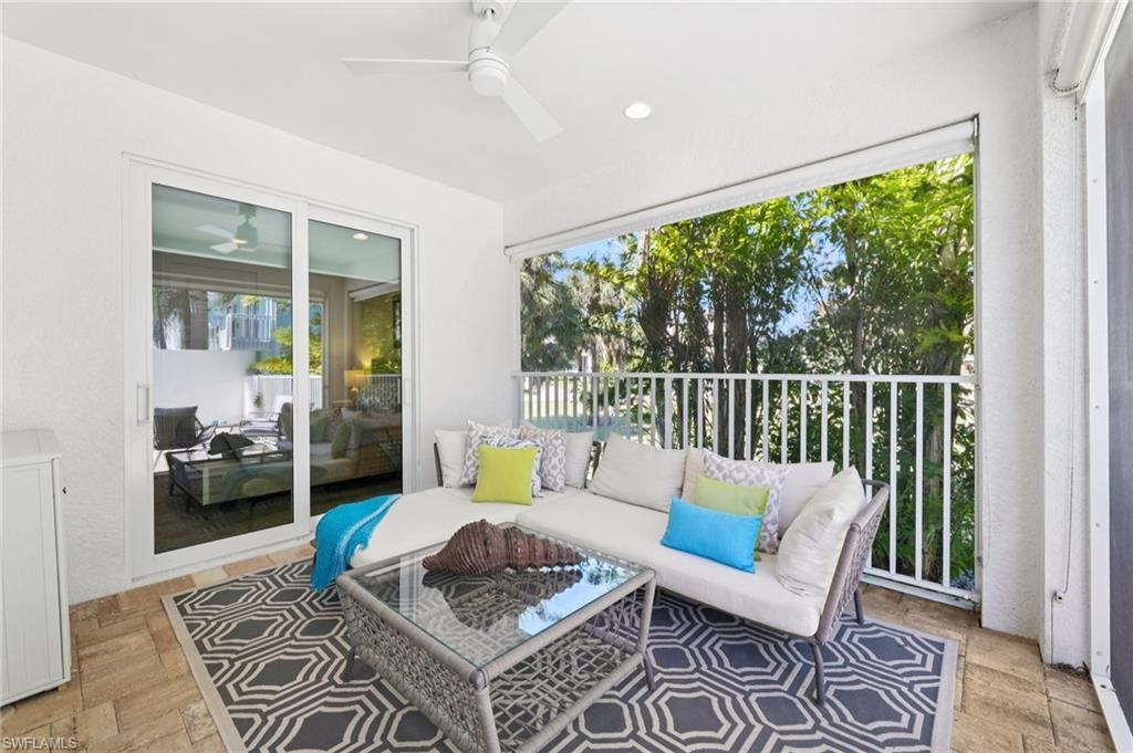 161 Tahiti Circle Naples, FL 34113 - Photo 32 of 42 a living room with furniture and a large window