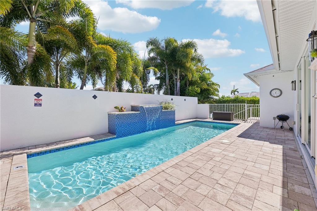 161 Tahiti Circle Naples, FL 34113 - Photo 35 of 42 View of swimming pool featuring patio surround and a fenced backyard