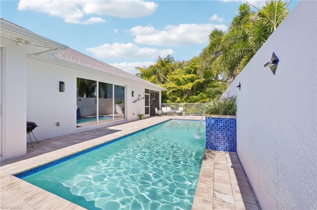 161 Tahiti Circle Naples, FL 34113 - Photo 37 of 42 View of swimming pool featuring patio surround and area for grilling