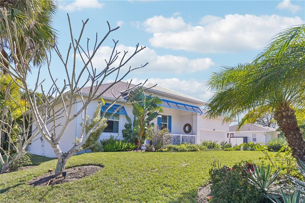 161 Tahiti Circle Naples, FL 34113 - Photo 4 of 42 a front view of a house with garden