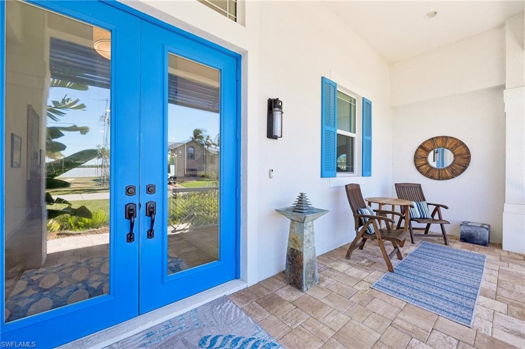 161 Tahiti Circle Naples, FL 34113 - Photo 6 of 42 a view of a dining room with furniture and chandelier