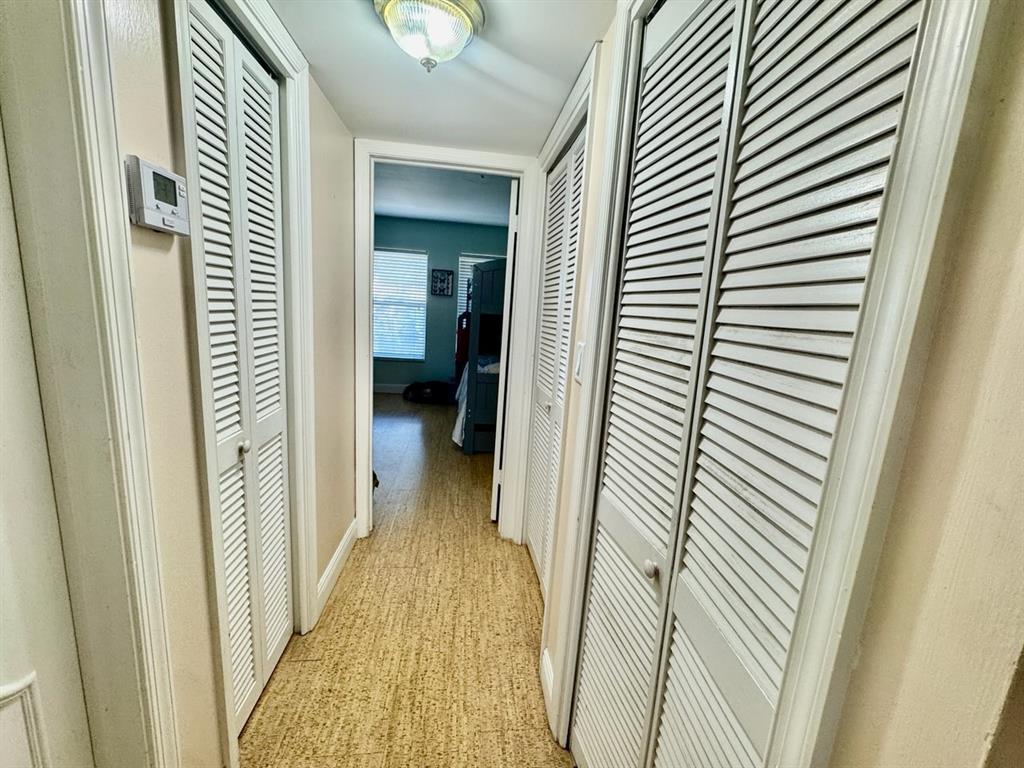 800 East Camino Real, Unit PH4160 Boca Raton, FL 33432 - Photo 18 of 22 a view of a hallway with wooden floor and staircase