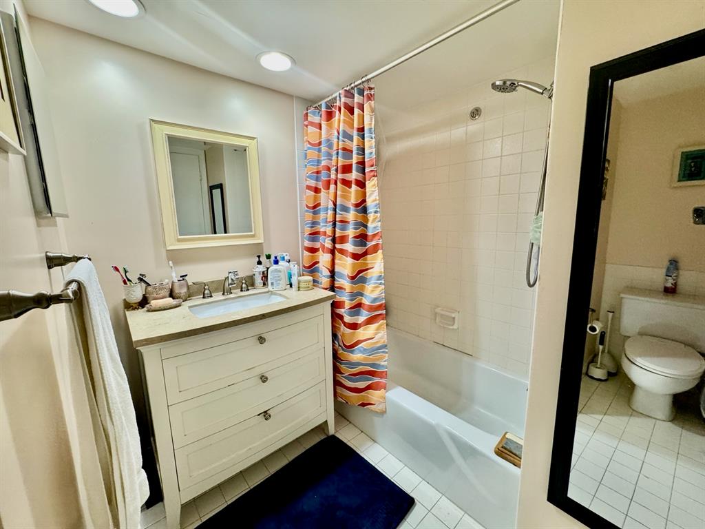 800 East Camino Real, Unit PH4160 Boca Raton, FL 33432 - Photo 20 of 22 a bathroom with a sink a toilet and shower