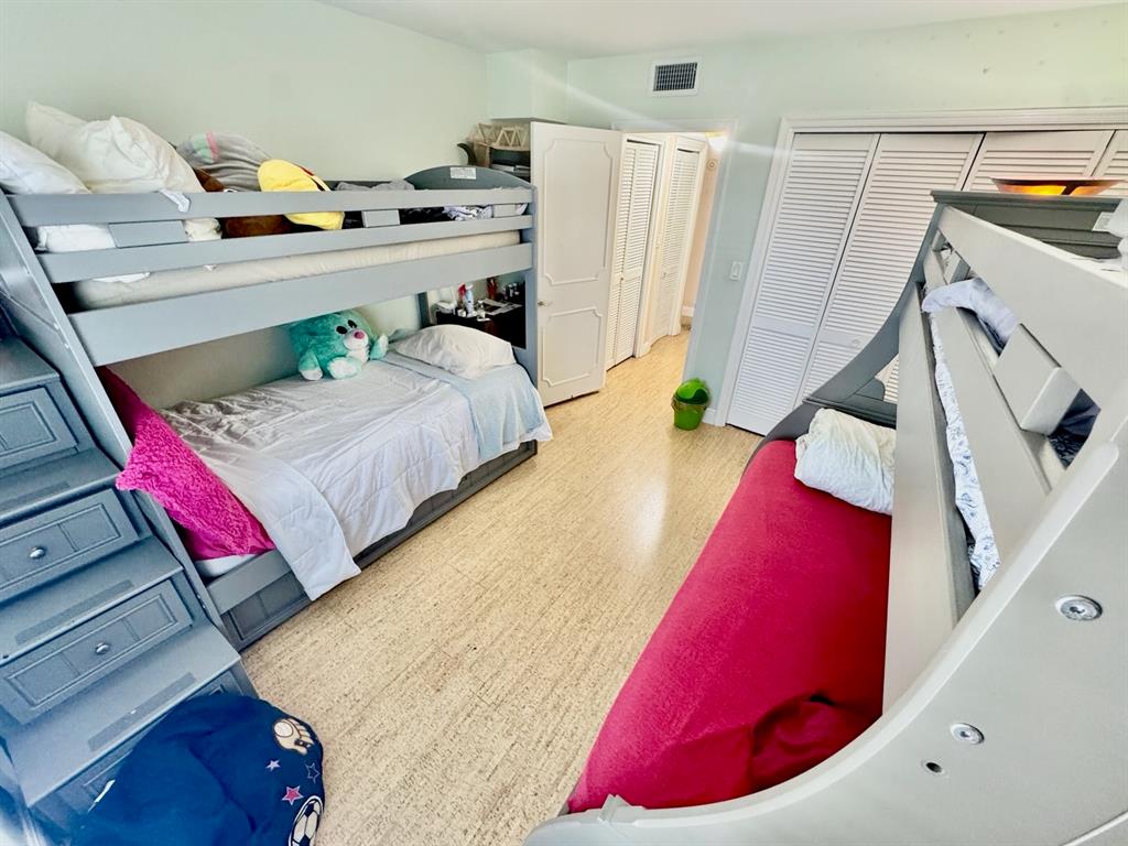 800 East Camino Real, Unit PH4160 Boca Raton, FL 33432 - Photo 22 of 22 a bedroom with a bed and a potted plant