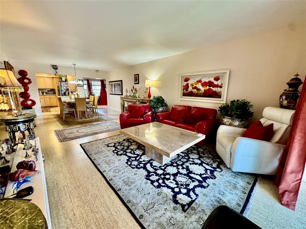 800 East Camino Real, Unit PH4160 Boca Raton, FL 33432 - Photo 4 of 22 a living room with furniture rug and window