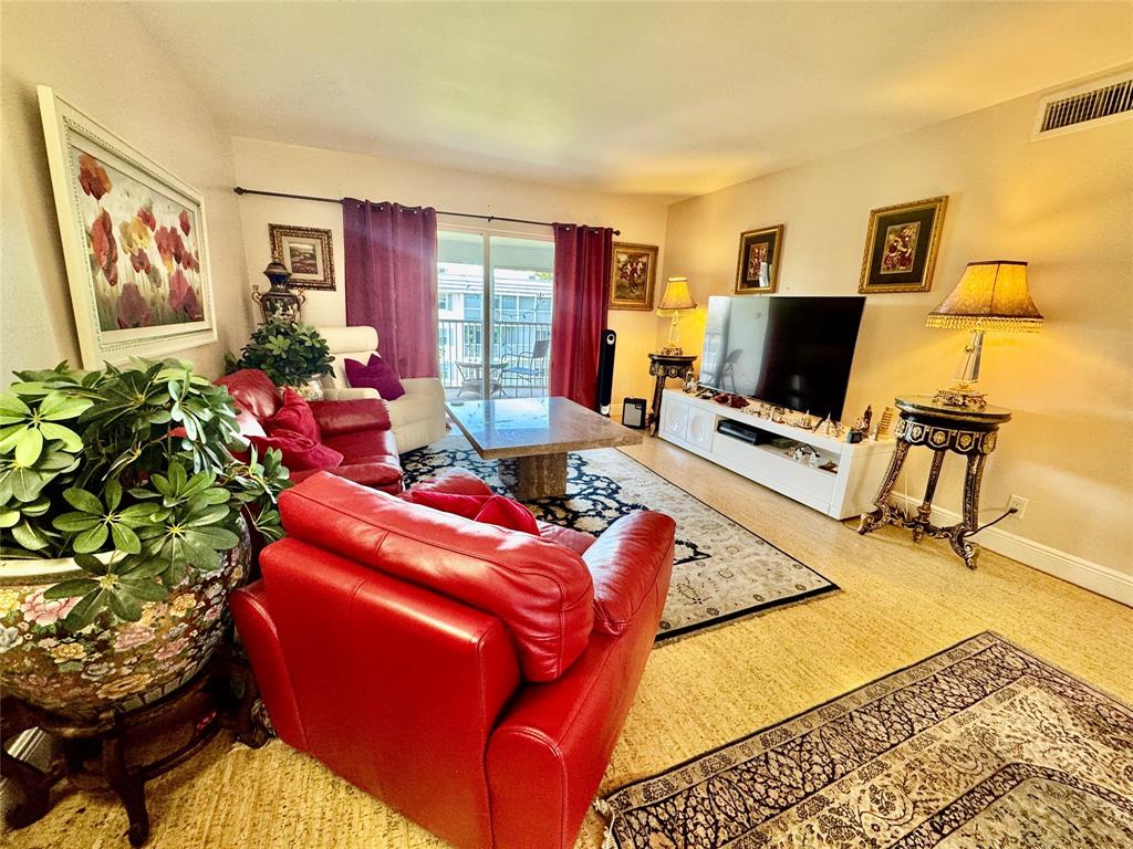 800 East Camino Real, Unit PH4160 Boca Raton, FL 33432 - Photo 5 of 22 a living room with a couch and a flat screen tv