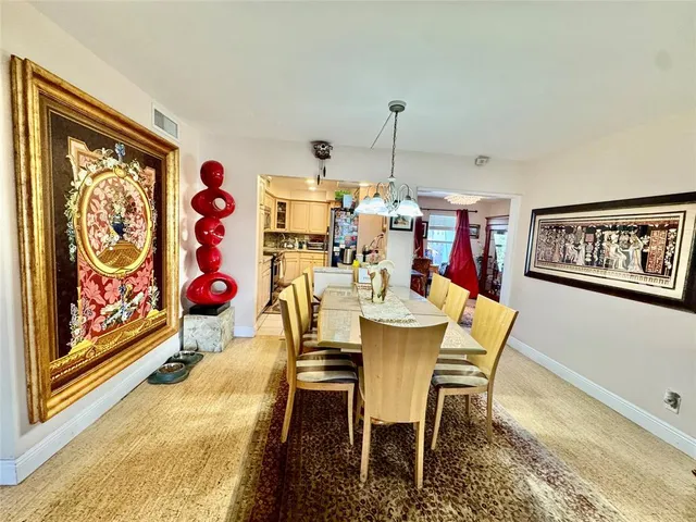 a view of a dining room with furniture and chandelier