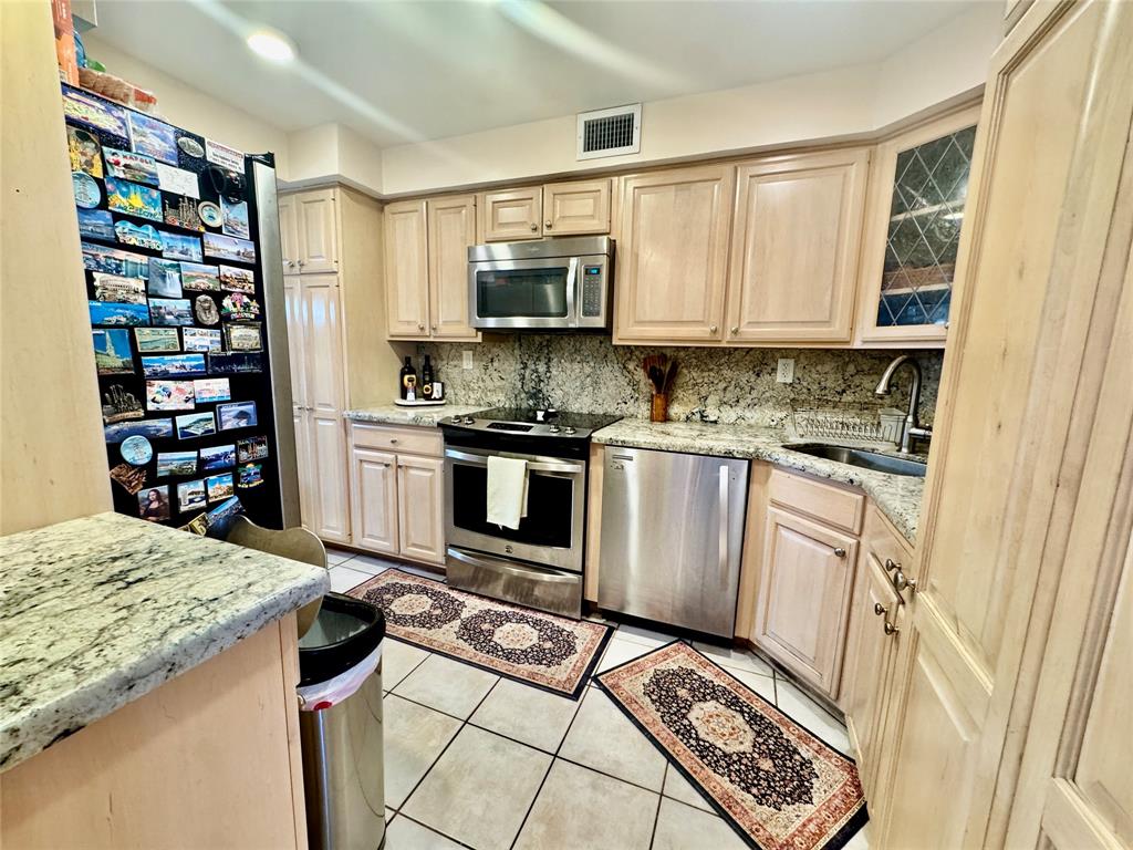 800 East Camino Real, Unit PH4160 Boca Raton, FL 33432 - Photo 7 of 22 a kitchen with stainless steel appliances granite countertop a stove a sink and a refrigerator