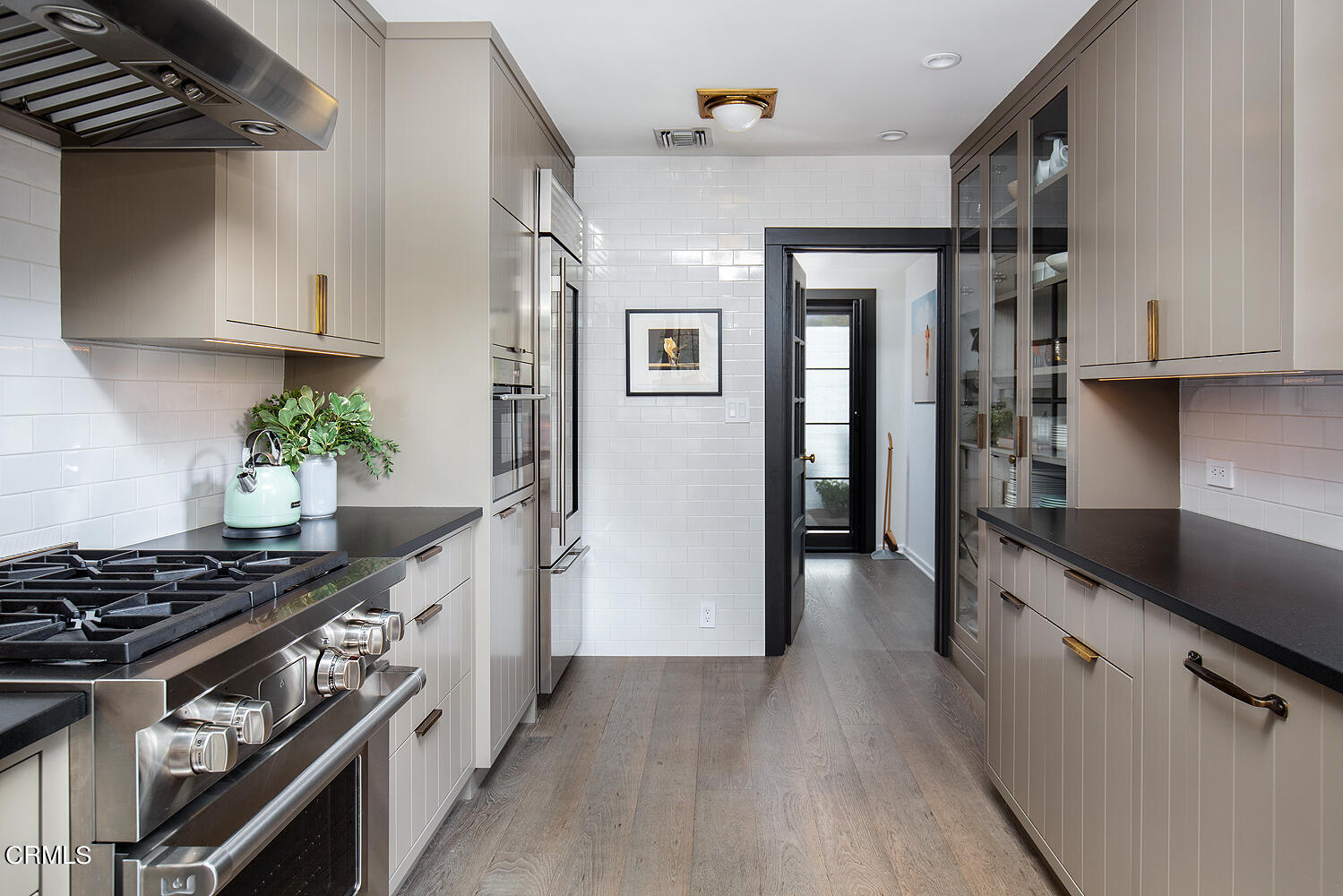 1146 Wotkyns Drive Pasadena, CA 91103 - Photo 23 of 63 a kitchen with stainless steel appliances a stove a sink and a refrigerator