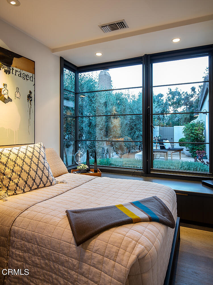 1146 Wotkyns Drive Pasadena, CA 91103 - Photo 61 of 63 a bedroom with a bed and glass window