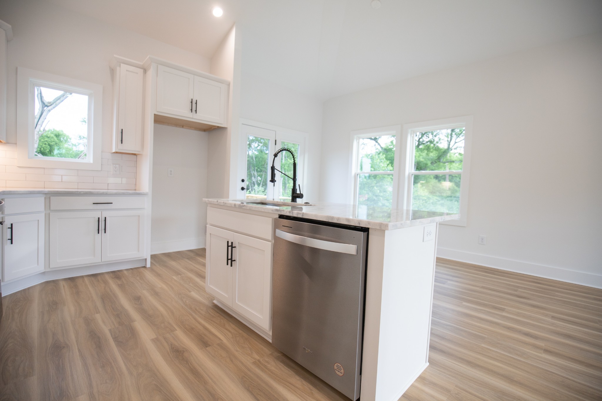 308 Larkin Springs Road Madison, TN 37115 - Photo 13 of 25 a kitchen with white cabinets and wooden floors