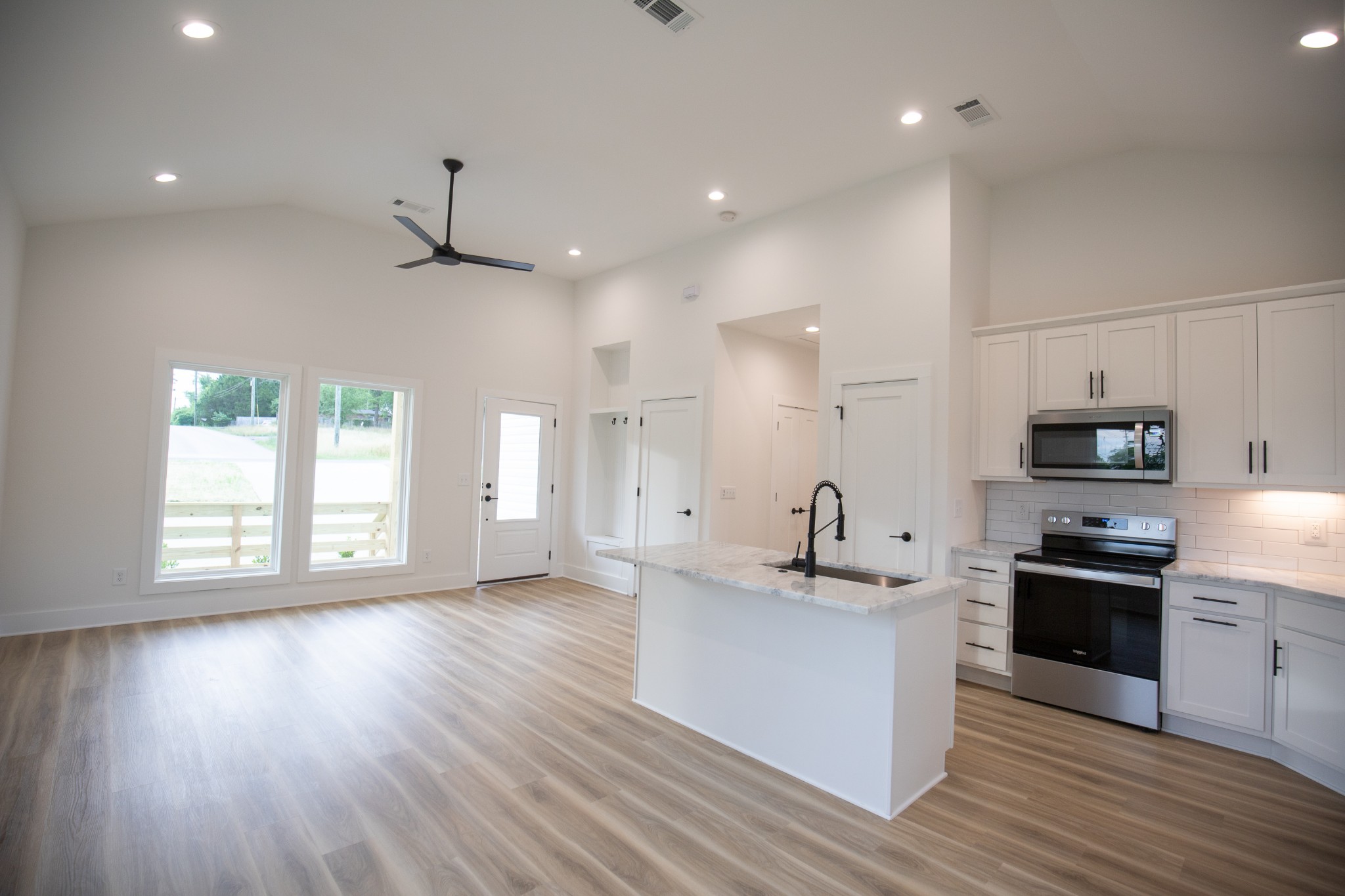 308 Larkin Springs Road Madison, TN 37115 - Photo 4 of 25 a kitchen with granite countertop a sink cabinets and wooden floor