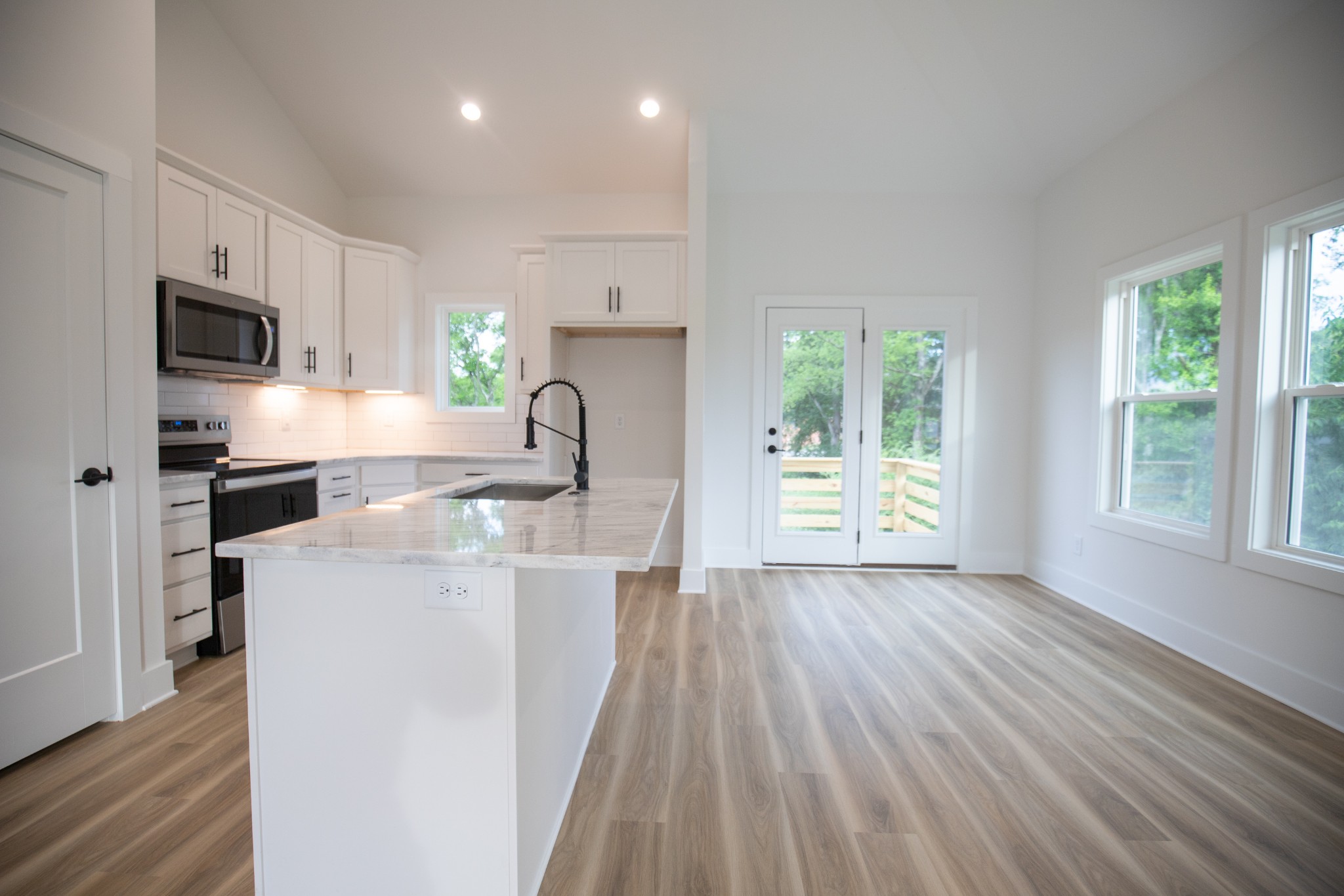 308 Larkin Springs Road Madison, TN 37115 - Photo 8 of 25 a kitchen with kitchen island wooden floors and stainless steel appliances