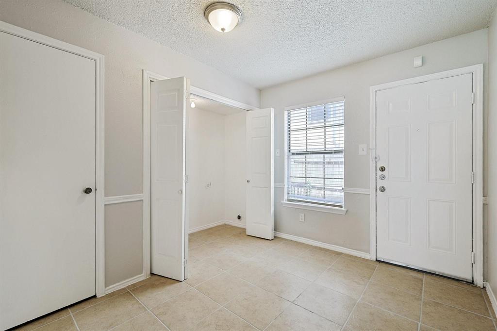 8005 Rothington Road, Unit 1117 Dallas, TX 75227 - Photo 8 of 13 Entryway featuring light tile patterned floors and a textured ceiling