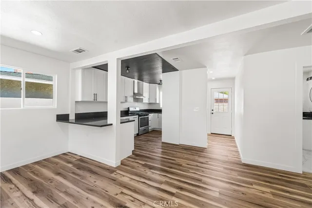a view of a kitchen with wooden floor and a kitchen