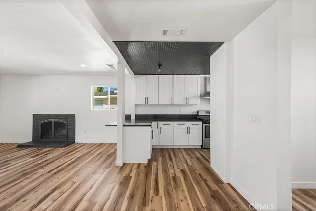 a kitchen with cabinets appliances and a wooden floor