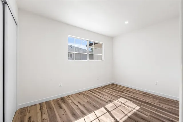 a view of a bedroom with wooden floor and bedroom