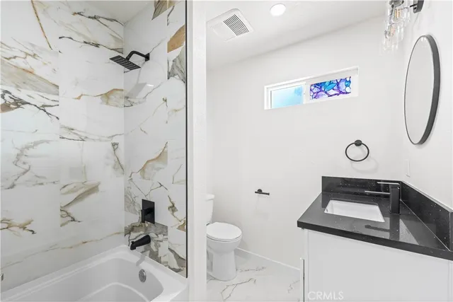 a bathroom with a toilet sink and tub
