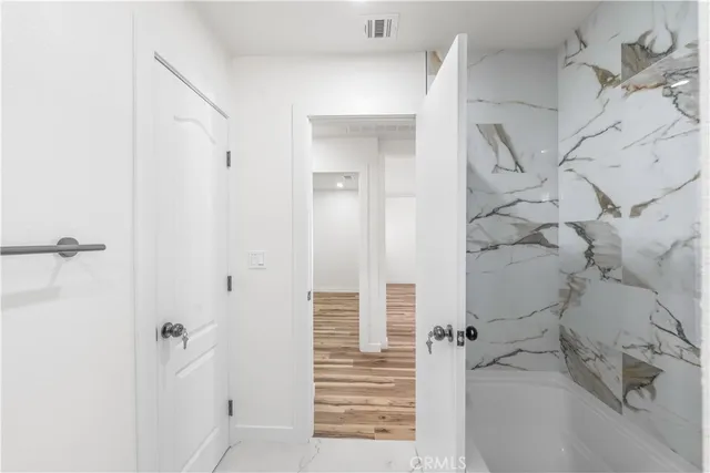 a bathroom with a bathtub and shower