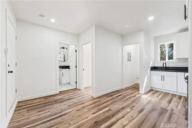 a view of empty room with wooden floor