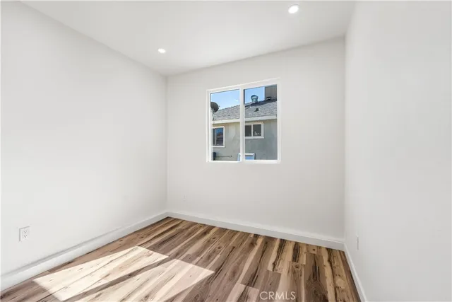 a view of a room with wooden floor and cabinet