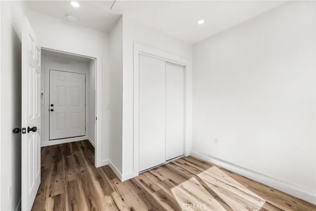 a view of a room with wooden floor and bathroom
