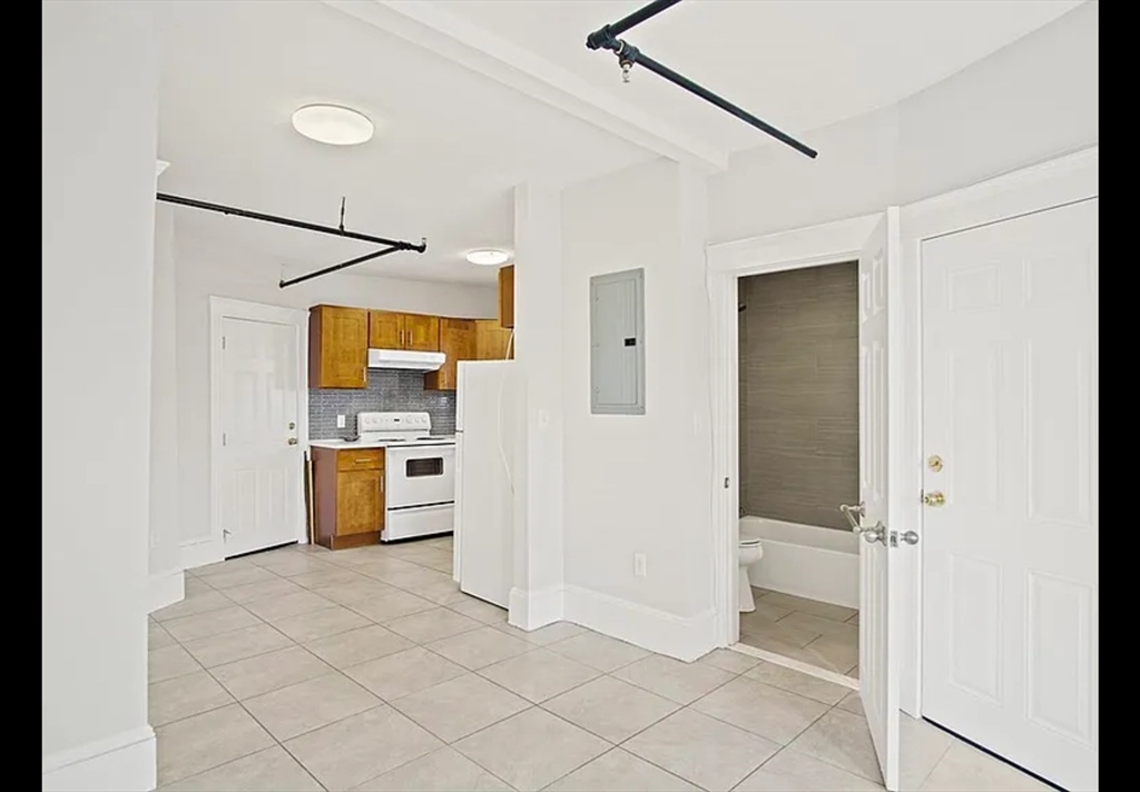 2 Redfield Street, Unit 2 Boston, MA 02122 - Photo 2 of 14 a view of a kitchen with a refrigerator and a stove top oven